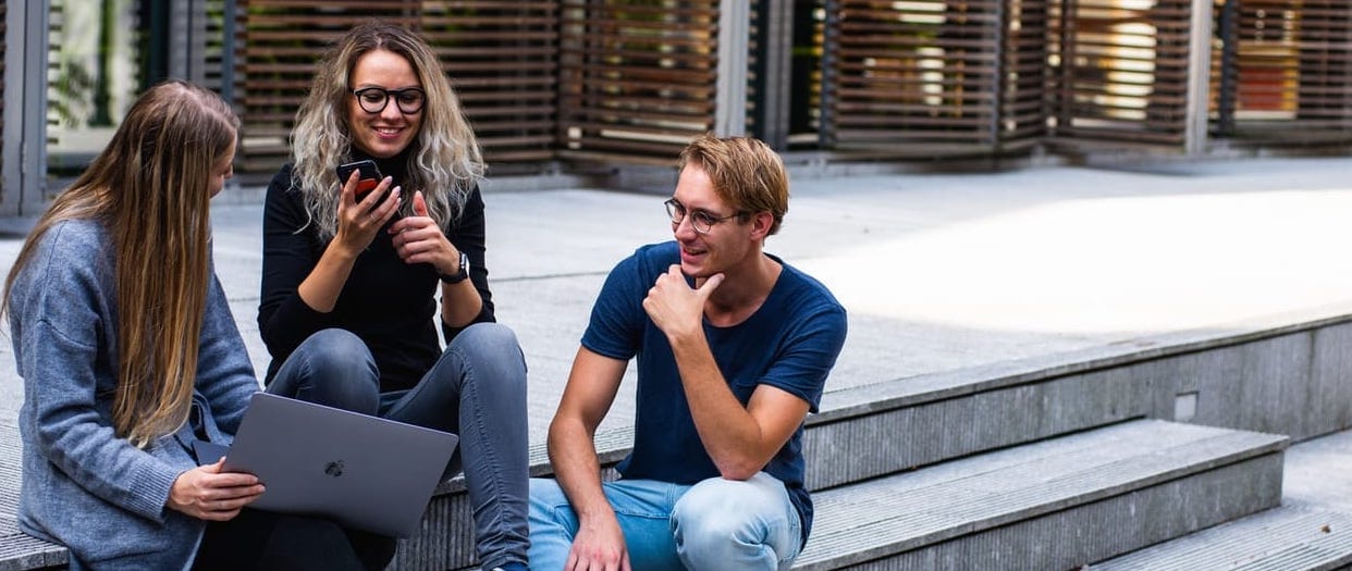 students sitting on university stairs