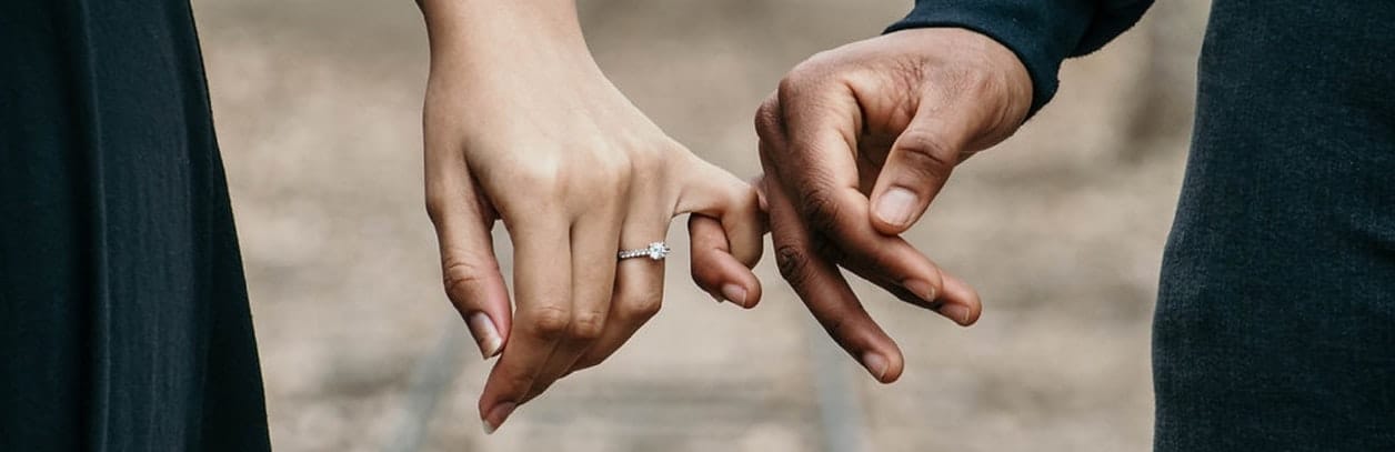 engaged couple holding hands